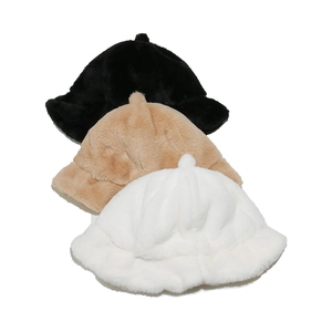 Overhead view of plush ruffle bucket hats in black, camel, and white soft faux fur