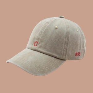 Close-up of vintage khaki baseball cap with red embroidered C and 1999 detail