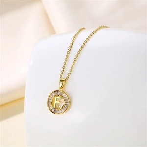 Close-up of 18K gold stainless steel pendant featuring a diamond-encrusted letter F design