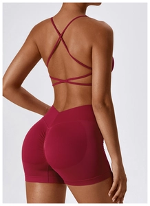Deep red seamless yoga bra with cross-strap back design for athletic support and style