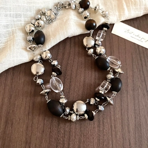 Close-up of vintage beaded necklace with dark wood beads and silver metal details