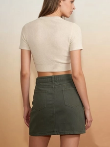 Close-up of high-waist dark green denim mini skirt with double back pockets detail