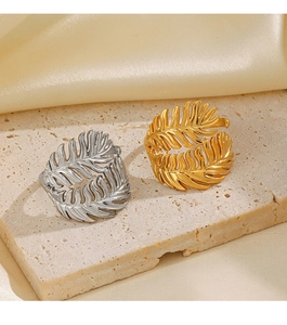 Detailed macro view of gold and silver leaf rings with intricate feather textures