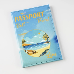 Blue faux leather passport cover with colorful beach scene illustration and travel quotes