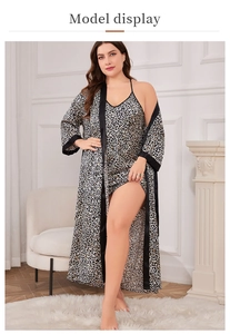 Detail view of leopard print satin robe set with elegant black trim and silk texture