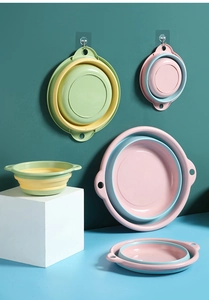 Multiple sizes of foldable silicone washbasins in blue and yellow showing storage options