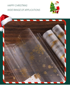 Detail of transparent Christmas cellophane wrap with gold snowflakes on wood background