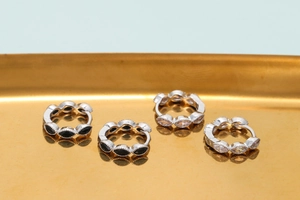 Silver micro-p镶嵌 cubic zirconia hoop earrings with teardrop gems on a golden tray