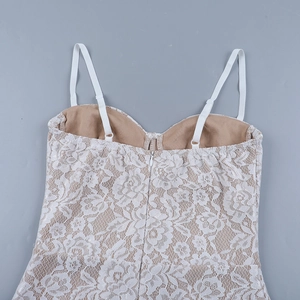 Detail of white floral lace dress featuring adjustable straps and hidden back zipper