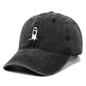 Close-up of ghost embroidery detail on charcoal gray washed cotton baseball cap