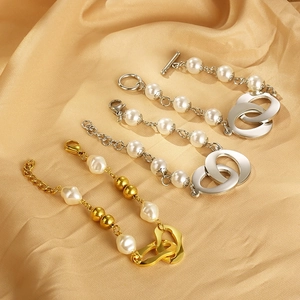 Fashionable linked chain and pearl bracelet with OT buckle on champagne satin fabric