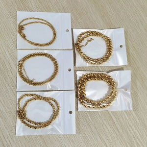 Detail of five rose gold bead necklaces with extension chains and lobster clasps