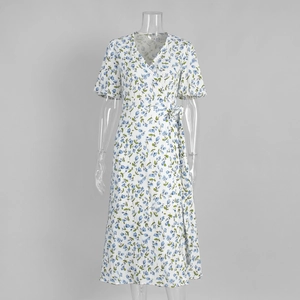 Detail of floral print cotton dress showing V-neck design and puff sleeves for women