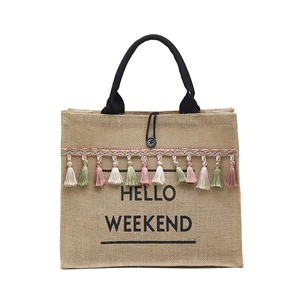 Linen tote bag with Hello Weekend print and colorful tassels for shopping and travel