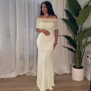 Detail of white off-shoulder maxi dress with ruched mesh patchwork and floor-length design