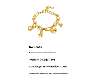 Detail of 18K gold stainless steel chain bracelet with bear, heart, and bow charms