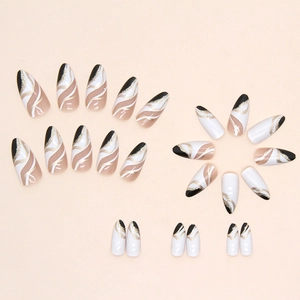 Almond-shaped press-on nails set featuring black, white, and gold glitter wavy patterns