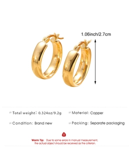 Detail view of 2.7cm gold hoop earrings in polished copper with weight specifications