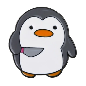 Macro detail of cartoon penguin enamel pin holding a knife with polished finish