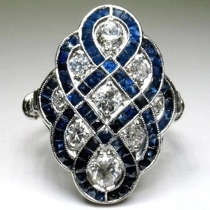 Detail of vintage Art Deco ring with blue sapphire and crystal in geometric setting