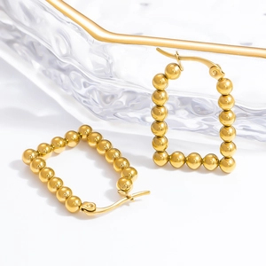 Close-up of gold-plated stainless steel square frame bead earrings with metallic luster