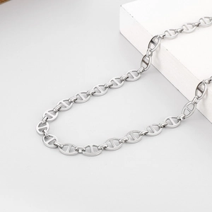 Detailed view of silver pig nose anchor chain necklace with a minimalist OT buckle design