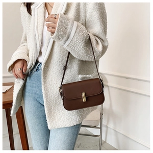 Retro dark brown leather saddle bag with gold metal buckle and adjustable shoulder strap