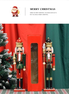 Set of two classic wooden nutcracker soldiers in red and green festive gift packaging box