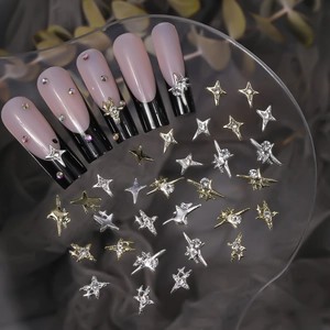 Detailed view of Y2K mini star nail charms and 3D cross star jewels on French nails
