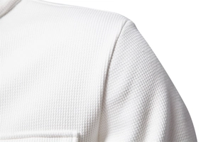 Detailed macro shot of white waffle textured fabric and durable shoulder seam stitching