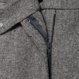 Dark grey textured trousers with premium metal zipper and button closure detail