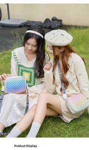 Close-up of V-quilted gradient crossbody camera bags with stylish wide printed straps