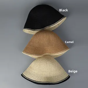Detailed view of woven bucket hats in black, beige, and camel with contrast trim