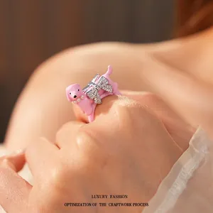 Pink enamel poodle ring with pearl collar and sparkling diamond-studded bow detail