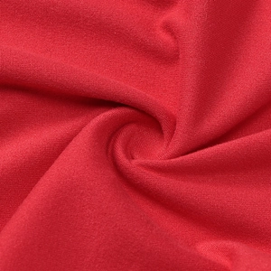 Macro shot of red knitted fabric texture with professional draped pleats detail