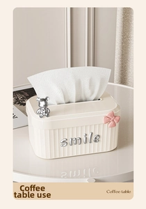 Detail of cream tissue box with silver bear, pink bow and 3D smile lettering