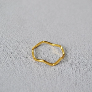 Minimalist gold plated brass ring featuring a stylish wavy curved band for layering