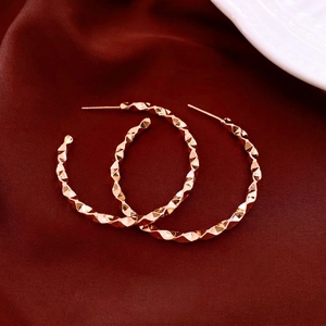 Geometric twisted multifaceted hoop earrings in rose gold finish for a modern look