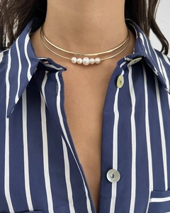 Detail of 18k gold stainless steel double choker with five elegant white pearls on model