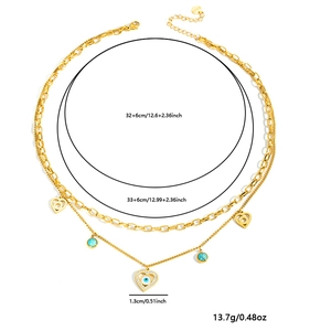 Collana doppia dorata con ciondolo cuore e occhio con misure di lunghezza 32-33 cm