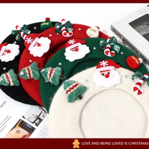 Detail of wool berets with Christmas elements like Santa and trees in multiple colors