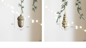 Macro detail of gold glitter acorn and pine tree ornaments with size and weight specs