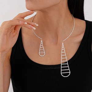 Detailed close-up of a silver rhinestone-studded open choker with geometric droplet pendants