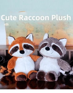 Detailed view of two plush raccoon dolls in brown and grey with fluffy long tails