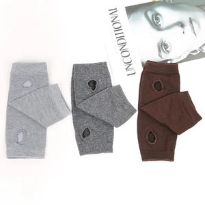 Detailed knit texture of fingerless arm warmers in grey and coffee with thumb holes
