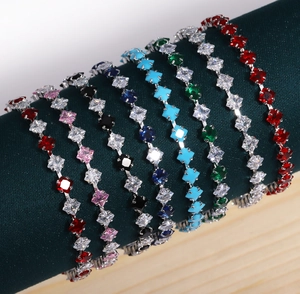 Macro detail of 18k gold plated square zircon tennis bracelets on a velvet display