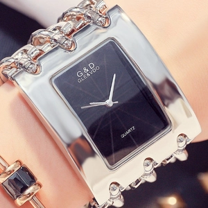 Close-up of women's silver quartz watch with rectangular dial and bold chain strap