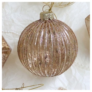 Detail of champagne gold vertical striped Christmas ball ornament with glitter finish