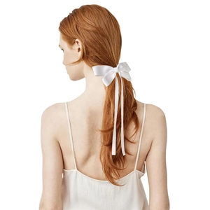 Elegant white satin ribbon bow hair clip on low ponytail for women's hairstyle