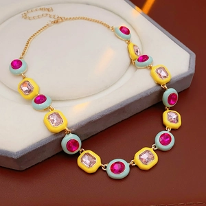Detail view of a vintage gold-plated necklace with pink stones in a jewelry box